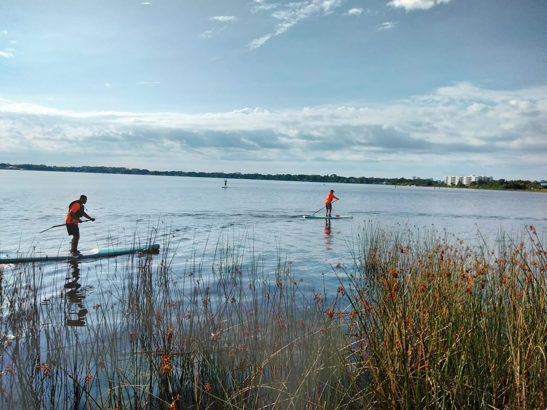 Stand-up paddleboarder on Lake Fairview at sunset