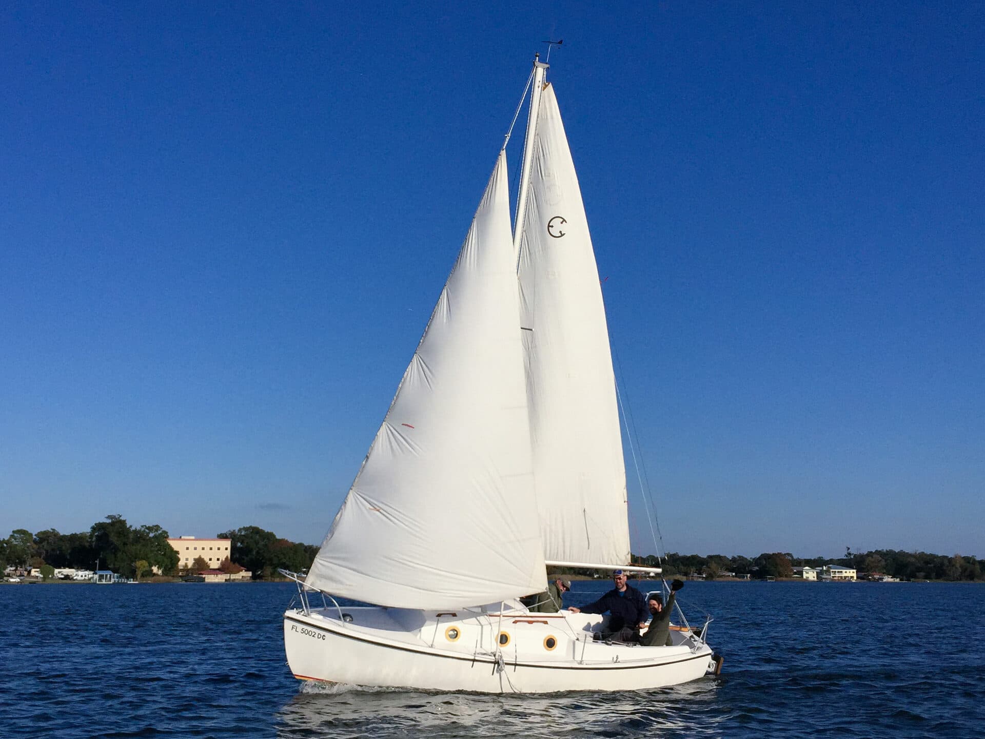Sailing instructor guiding students on Lake Fairview