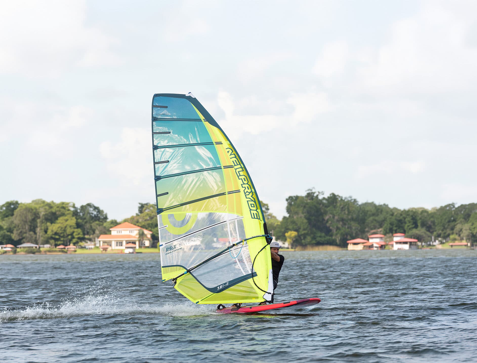 Beginner windsurfer being instructed on shore